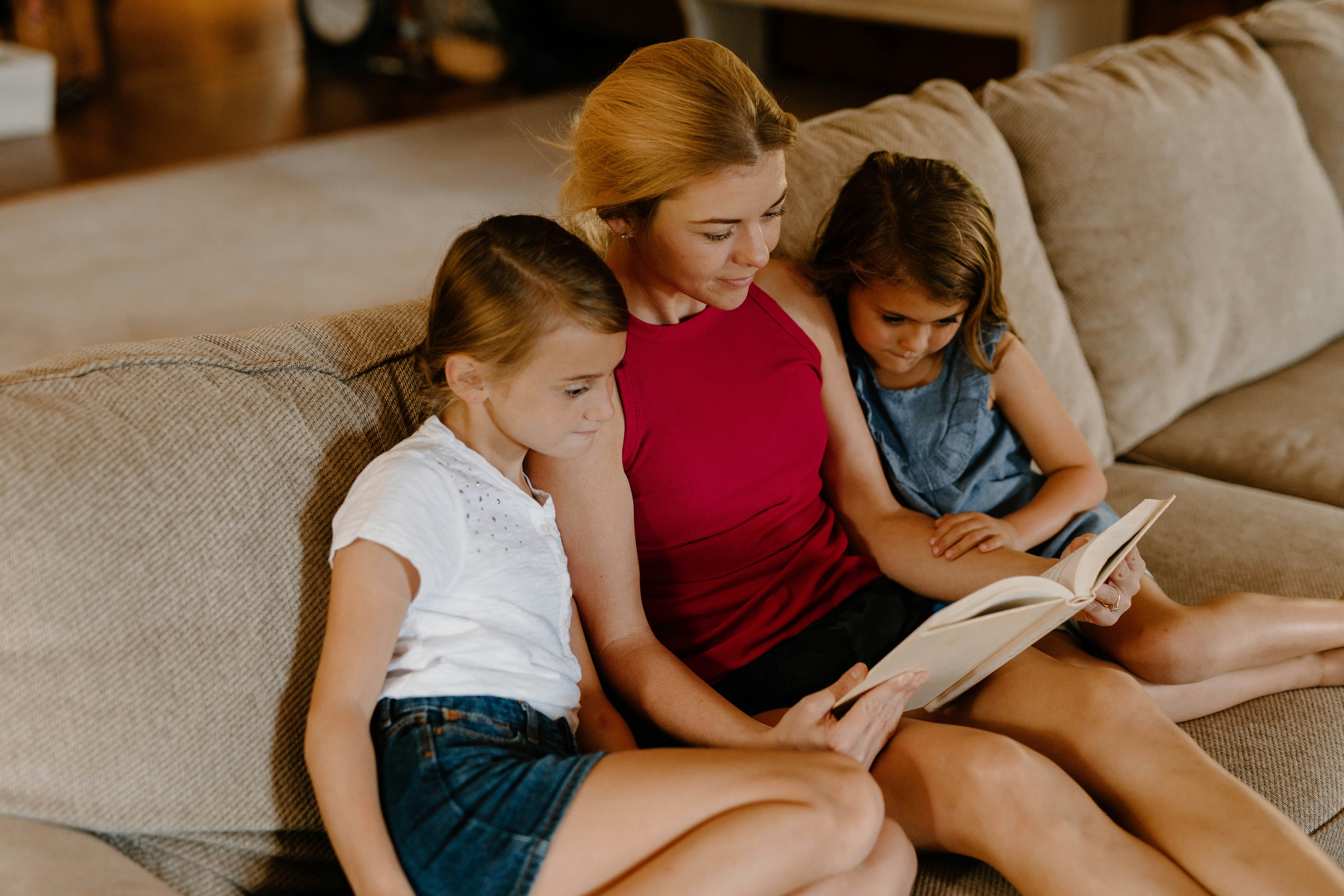 Adult reading a book to children